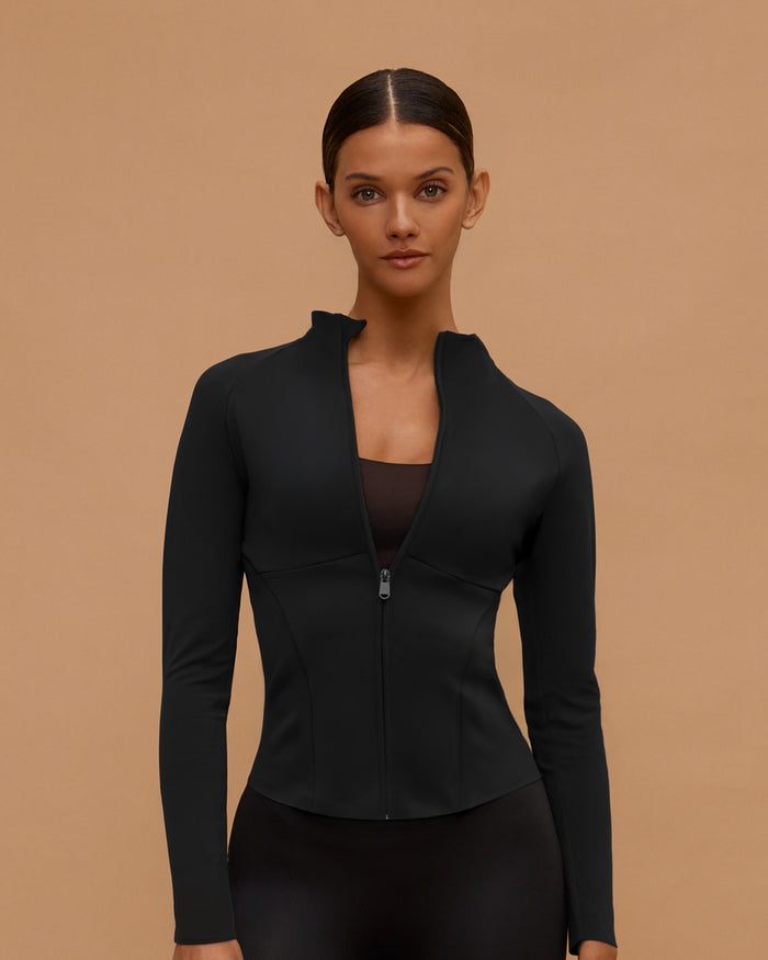 Woman wearing the Sculpt & Move Raglan Jacket in Black, front view, zipped up