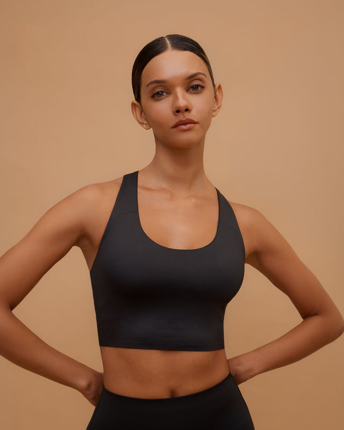 Woman wearing the Loop-Back Bra Tank in Black, front view
